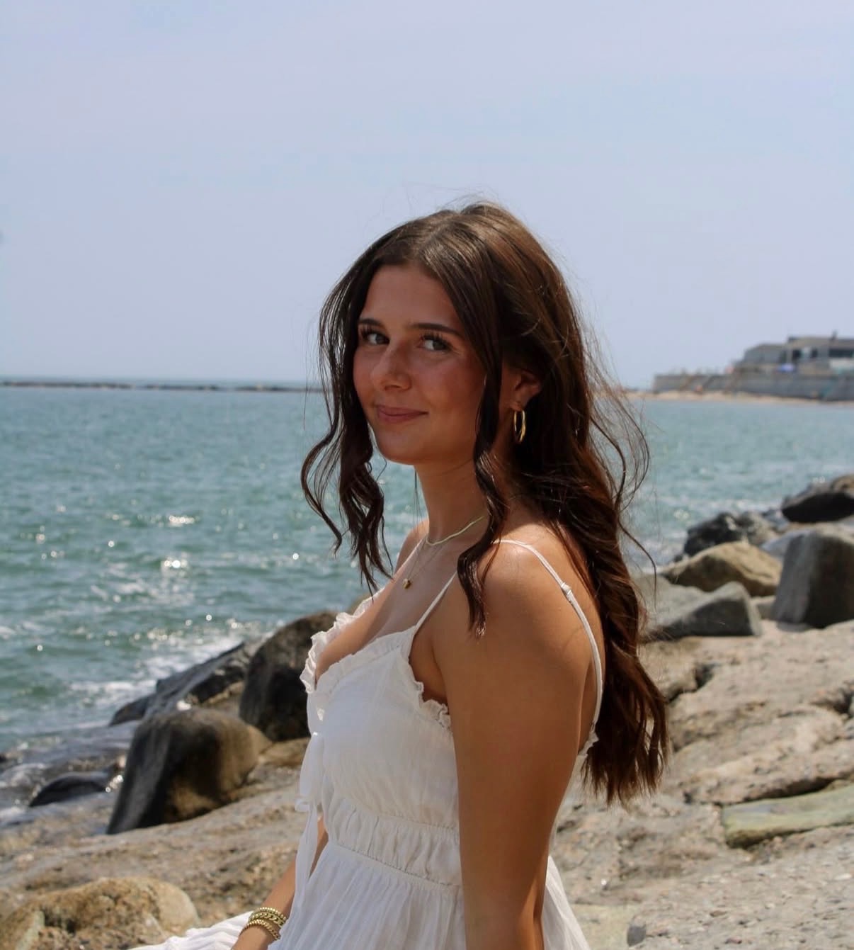 Summer portrait in a white dress by the ocean